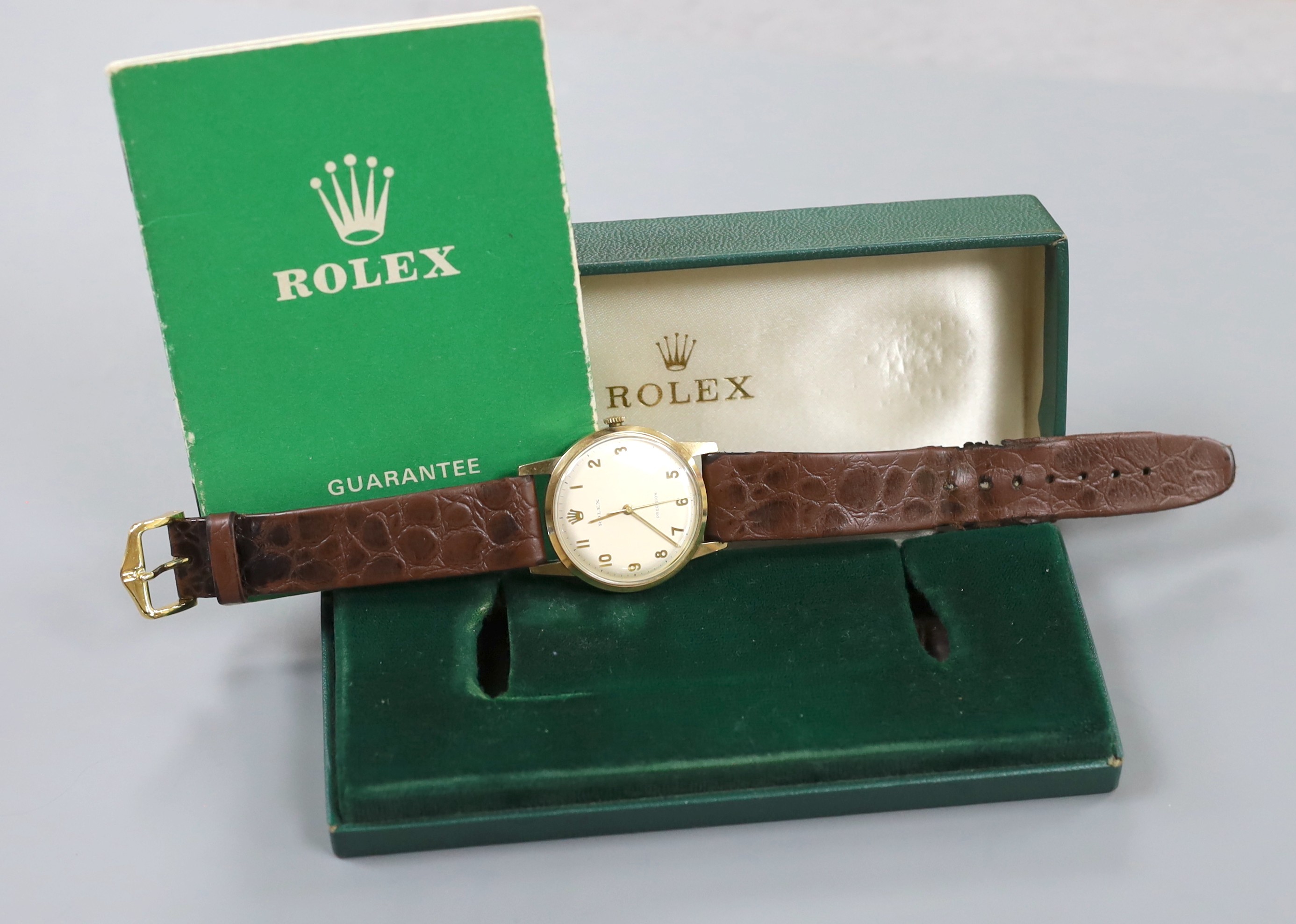 A gentleman's late 1960's 9ct gold Rolex precision manual wind wrist watch, with case back inscription, on associated leather strap, case diameter 34mm, gross weight 33.6 grams, with box and guarantee.